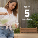 A woman outdoors pours a pale green liquid from a clear pitcher into a glass. Large white text on the right reads 'Only 5 Ingredients.